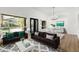 Open-concept living area with backyard view windows, a cozy seating area, and modern decor at 3102 E Desert Broom Way, Phoenix, AZ 85048