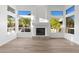 Bright living room with fireplace and large windows offering abundant natural light at 3102 E Desert Broom Way, Phoenix, AZ 85048
