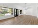 Spacious open-concept living area featuring wood-look floors and views of the backyard at 3102 E Desert Broom Way, Phoenix, AZ 85048