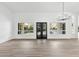 Bright and airy living area featuring wood-look floors and modern chandelier and backyard views at 3102 E Desert Broom Way, Phoenix, AZ 85048