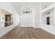 Bright and open living room with wood-look floors, stylish lighting, and arched design elements at 3102 E Desert Broom Way, Phoenix, AZ 85048