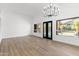 Bright living area featuring backyard views, modern lighting, and wood-look flooring at 3102 E Desert Broom Way, Phoenix, AZ 85048
