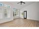 Bright, airy living room featuring hardwood floors, shuttered windows, and an entry door at 3102 E Desert Broom Way, Phoenix, AZ 85048