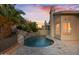 Gorgeous backyard pool featuring a rock waterfall, lush greenery, and a serene outdoor setting at 3102 E Desert Broom Way, Phoenix, AZ 85048