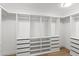 Walk-in closet features built in shelving and drawers to organize wardrobe at 3102 E Desert Broom Way, Phoenix, AZ 85048