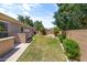 A spacious backyard showcases a fire pit, well-manicured lawn, and privacy fencing at 3225 E Cardinal Ct, Chandler, AZ 85286