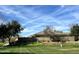 Manicured backyard featuring a lush green lawn, privacy wall and mature trees at 3225 E Cardinal Ct, Chandler, AZ 85286