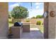 An outdoor kitchen with a grill is seen from the covered patio area, offering a functional and attractive space at 3225 E Cardinal Ct, Chandler, AZ 85286
