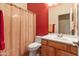 Cozy bathroom with vibrant coral accent wall, tiled flooring and a shower and tub combo at 3225 E Cardinal Ct, Chandler, AZ 85286
