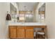 Bright bathroom featuring a makeup vanity, spacious countertop, oak cabinetry, and decorative mirrors at 3225 E Cardinal Ct, Chandler, AZ 85286