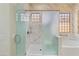 Luxurious bathroom with marble walls, glass-enclosed shower, and a soaking tub for relaxation at 3225 E Cardinal Ct, Chandler, AZ 85286