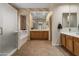 Bathroom view showcasing tile flooring, a walk-in shower, a soaking tub and dual sink vanity at 3225 E Cardinal Ct, Chandler, AZ 85286