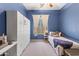 Blue bedroom with large windows, a ceiling fan, and built in cabinets at 3225 E Cardinal Ct, Chandler, AZ 85286