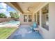 A cozy covered patio offers a view of the pool, lawn and garden and features tile flooring and comfortable seating at 3225 E Cardinal Ct, Chandler, AZ 85286