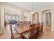 Elegant dining room with a large wooden table perfect for hosting gatherings, open to living spaces at 3225 E Cardinal Ct, Chandler, AZ 85286