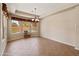 Spacious dining area with large windows that offer a view of the well-manicured backyard and pool at 3225 E Cardinal Ct, Chandler, AZ 85286