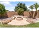 A custom built-in fire pit surrounded by seating creates an inviting space for outdoor gatherings at 3225 E Cardinal Ct, Chandler, AZ 85286
