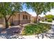 Attractive home with stone accents, a green lawn, and mature trees providing shade at 3225 E Cardinal Ct, Chandler, AZ 85286