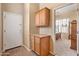 Hallway featuring built-in cabinets and a glimpse into a well-lit bedroom with a soaking tub at 3225 E Cardinal Ct, Chandler, AZ 85286