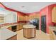 Bright kitchen showcasing an island, ample cabinetry, a black refrigerator, and tiled floors at 3225 E Cardinal Ct, Chandler, AZ 85286