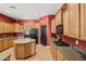 Kitchen with wood cabinets, modern appliances, a kitchen island and plenty of countertop space at 3225 E Cardinal Ct, Chandler, AZ 85286