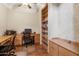 Home office featuring built-in wood desks, drawers, shelving and wood flooring at 3225 E Cardinal Ct, Chandler, AZ 85286