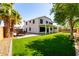 Expansive backyard with a covered patio and well-manicured artificial turf at 3444 E Flamingo Ct, Gilbert, AZ 85297