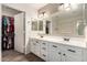 Bright bathroom with double sinks, plenty of storage, and a walk-in closet at 3444 E Flamingo Ct, Gilbert, AZ 85297
