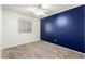Bedroom with blue accent wall, window, and ceiling fan at 3444 E Flamingo Ct, Gilbert, AZ 85297