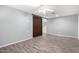 Bedroom featuring dark barn door, ceiling fan, and tile flooring at 3444 E Flamingo Ct, Gilbert, AZ 85297