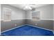 Bedroom with two-tone walls, blue carpet, ceiling fan, and two windows at 3444 E Flamingo Ct, Gilbert, AZ 85297