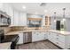 Well-lit kitchen features stainless steel appliances, white cabinetry, stylish countertops, and wood-look flooring at 3444 E Flamingo Ct, Gilbert, AZ 85297