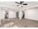 Large living area featuring wood-look flooring, ceiling fan, and staircase at 3444 E Flamingo Ct, Gilbert, AZ 85297