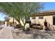 Serene backyard with stone pathway and gravel, landscaped garden, and patio with seating at 36674 N Vasari Dr, Scottsdale, AZ 85262