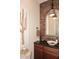 Well-lit bathroom with decorative mirror, accent wall, and vessel sink offering a modern, spa-like experience at 36674 N Vasari Dr, Scottsdale, AZ 85262