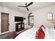 Bedroom featuring a wooden bed frame, ceiling fan, and window with blinds at 36674 N Vasari Dr, Scottsdale, AZ 85262