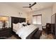 Bedroom featuring a wooden bed frame, ceiling fan, and neutral walls at 36674 N Vasari Dr, Scottsdale, AZ 85262