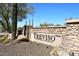 Elegant stone entrance sign for Treviso West, a Toll Brothers community, under a clear blue sky at 36674 N Vasari Dr, Scottsdale, AZ 85262