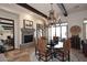 Elegant dining area featuring a fireplace, chandelier, and large windows at 36674 N Vasari Dr, Scottsdale, AZ 85262