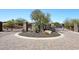 Circular entrance with stone pillars, iron gate, and desert landscaping at 36674 N Vasari Dr, Scottsdale, AZ 85262