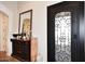 Welcoming foyer with decorative mirror, console table, and stylish door at 36674 N Vasari Dr, Scottsdale, AZ 85262