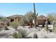 Desert home with a tile roof, stucco exterior, and mature desert landscaping with various cactus at 36674 N Vasari Dr, Scottsdale, AZ 85262