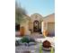 Charming front entry featuring a brick walkway, decorative planters, and desert landscaping at 36674 N Vasari Dr, Scottsdale, AZ 85262