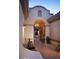 Inviting front entry with a brick walkway, decorative lighting, and an ornate gate at 36674 N Vasari Dr, Scottsdale, AZ 85262