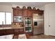 This gourmet kitchen boasts granite countertops, stainless steel appliances, and dark wood cabinetry at 36674 N Vasari Dr, Scottsdale, AZ 85262