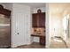 Charming kitchenette area with custom cabinetry, granite countertop, and convenient hallway access at 36674 N Vasari Dr, Scottsdale, AZ 85262