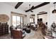 Spacious living room boasts exposed beams, tile floors and abundant seating at 36674 N Vasari Dr, Scottsdale, AZ 85262