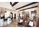 Inviting living space with exposed beams, bar, and connected dining room at 36674 N Vasari Dr, Scottsdale, AZ 85262