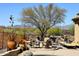 Inviting outdoor living space with a built-in barbecue, comfortable seating, and desert views at 36674 N Vasari Dr, Scottsdale, AZ 85262