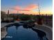Backyard swimming pool at sunset surrounded by lush desert landscaping and comfortable seating at 36674 N Vasari Dr, Scottsdale, AZ 85262